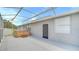 Screened-in patio features a hot tub, neutral siding, and an exterior door at 3824 Blue Dasher Dr, Kissimmee, FL 34744
