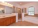 Bright bathroom features a glass shower enclosure and separate soaking tub beneath an arched window at 3904 Coastal Breeze Dr, Kissimmee, FL 34744