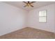 Bare bedroom featuring carpet, ceiling fan, and a window at 3904 Coastal Breeze Dr, Kissimmee, FL 34744