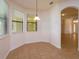 Bright breakfast nook with natural light and tile flooring adjacent to an arched doorway at 3904 Coastal Breeze Dr, Kissimmee, FL 34744