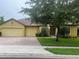 Charming single-story home with a brick driveway, a well-manicured lawn, and mature trees providing ample shade at 3904 Coastal Breeze Dr, Kissimmee, FL 34744
