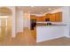 Kitchen with oak cabinetry, black appliances, and bar top seating at 3904 Coastal Breeze Dr, Kissimmee, FL 34744