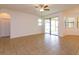 Spacious living room with tile floors, ceiling fan, and sliding glass doors to the patio at 3904 Coastal Breeze Dr, Kissimmee, FL 34744