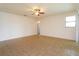 Large living room with tile flooring, ceiling fan, and a neutral color palette at 3904 Coastal Breeze Dr, Kissimmee, FL 34744
