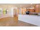 Open floorplan featuring a breakfast bar connecting the kitchen and dining area with tile floors at 3904 Coastal Breeze Dr, Kissimmee, FL 34744