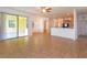 Open floorplan with tile flooring, connecting living area to the kitchen and patio access at 3904 Coastal Breeze Dr, Kissimmee, FL 34744