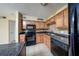 Efficient kitchen with stainless appliances, tile floors, and warm wood cabinetry at 420 Forestway Cir # 206, Altamonte Springs, FL 32701