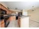 Bright kitchen featuring wood cabinets, stone countertops, and a breakfast bar at 420 Forestway Cir # 206, Altamonte Springs, FL 32701