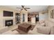 Cozy staged living room with fireplace and a partial view of a modern kitchen at 420 Forestway Cir # 206, Altamonte Springs, FL 32701