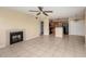 Open living room with tile floors, fireplace, ceiling fan, and a partial view of the kitchen at 420 Forestway Cir # 206, Altamonte Springs, FL 32701
