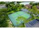 Aerial view of community tennis courts surrounded by mature trees, parking and community buildings at 420 Forestway Cir # 206, Altamonte Springs, FL 32701