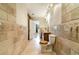 Spacious bathroom featuring tile walls, modern vanity, and connection to the primary bedroom at 4300 Lake Underhill Rd # D, Orlando, FL 32803