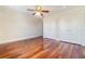 Bedroom featuring hardwood floors, a ceiling fan, and ample closet space at 4300 Lake Underhill Rd # D, Orlando, FL 32803