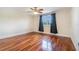 Bright bedroom with hardwood floors, black-out curtains, and a ceiling fan at 4300 Lake Underhill Rd # D, Orlando, FL 32803
