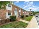 Inviting brick townhouse showcasing a well-maintained lawn and lush landscaping at 4300 Lake Underhill Rd # D, Orlando, FL 32803