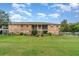 Well-maintained brick apartment building with manicured lawn, enhancing the community's appeal at 4300 Lake Underhill Rd # D, Orlando, FL 32803