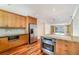 Well-appointed kitchen with stainless steel appliances, granite counters, and wooden cabinetry at 4300 Lake Underhill Rd # D, Orlando, FL 32803