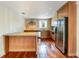 Beautiful kitchen with hardwood floors, wooden cabinets, stainless steel appliances, and granite counters at 4300 Lake Underhill Rd # D, Orlando, FL 32803
