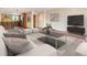 Bright living room with hardwood floors, modern decor, and an open concept design to kitchen with stainless steel appliances at 4300 Lake Underhill Rd # D, Orlando, FL 32803