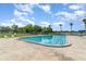 Enjoy a refreshing dip in the large community pool, surrounded by lounge chairs and tropical palm trees at 4300 Lake Underhill Rd # D, Orlando, FL 32803