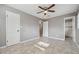 This bedroom features neutral walls, ceiling fan and tile flooring leading to a bathroom at 510 Peach Tree Ln, Altamonte Springs, FL 32701