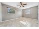 Inviting bedroom with tile floors, a ceiling fan, and ample natural light from two windows at 510 Peach Tree Ln, Altamonte Springs, FL 32701