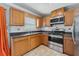 Well-equipped kitchen featuring stainless steel appliances, wood cabinetry and laminate countertops at 510 Peach Tree Ln, Altamonte Springs, FL 32701