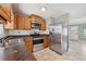 Functional kitchen with wood cabinets, modern appliances, and convenient access to the living space at 510 Peach Tree Ln, Altamonte Springs, FL 32701