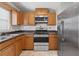 Close-up of a well-equipped kitchen featuring stainless steel appliances and wood cabinetry at 510 Peach Tree Ln, Altamonte Springs, FL 32701