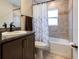 Full bathroom features a granite countertop, a combination tub and shower, and neutral tile at 5416 Tessin Trl, St Cloud, FL 34771