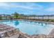 Large community pool with plenty of lounge chairs for residents to relax and enjoy the sun at 5416 Tessin Trl, St Cloud, FL 34771