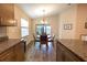 Bright dining area with a view of the lanai, featuring a stylish chandelier and wood floors at 5416 Tessin Trl, St Cloud, FL 34771