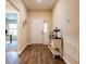 Inviting foyer with stylish wood-look flooring, a charming accent table, and a view into the home at 5416 Tessin Trl, St Cloud, FL 34771