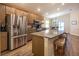 Well-appointed kitchen with a large island, stainless steel refrigerator, and a breakfast bar at 5416 Tessin Trl, St Cloud, FL 34771