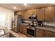 Modern kitchen featuring stainless steel appliances, granite countertops, and ample cabinet space at 5416 Tessin Trl, St Cloud, FL 34771