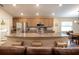 Open kitchen with granite countertops, stainless steel appliances, and a breakfast bar overlooking the living area at 5416 Tessin Trl, St Cloud, FL 34771
