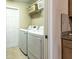 Practical laundry room with modern appliances, storage, and tile flooring at 5416 Tessin Trl, St Cloud, FL 34771