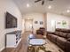 Comfortable living room with vaulted ceilings, hardwood floors, a ceiling fan, and plenty of natural light at 5416 Tessin Trl, St Cloud, FL 34771