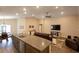 Spacious open-concept living area with an eat-in kitchen, vaulted ceilings, and wood-look flooring at 5416 Tessin Trl, St Cloud, FL 34771