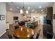 Open-concept living space with a modern kitchen, comfortable seating, and hardwood floors at 5416 Tessin Trl, St Cloud, FL 34771