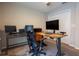 Office space featuring dual desks, a ceiling fan, and storage at 5416 Tessin Trl, St Cloud, FL 34771