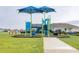 Colorful community playground featuring slides, climbing structures, and a bench for parents at 5416 Tessin Trl, St Cloud, FL 34771
