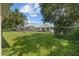 Spacious backyard with lush lawn and chain-link fence, perfect for outdoor activities at 621 Bluebill Ln, Poinciana, FL 34759