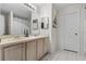 Bathroom with double vanity and a large mirror and tiled floors at 621 Bluebill Ln, Poinciana, FL 34759