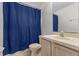 Bathroom featuring a blue shower curtain and a light-colored vanity at 621 Bluebill Ln, Poinciana, FL 34759