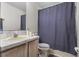Functional bathroom with a shower-tub combo, neutral colored walls and vanity storage at 621 Bluebill Ln, Poinciana, FL 34759