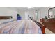 This primary bedroom features a patterned bedspread, ample lighting and dresser storage at 621 Bluebill Ln, Poinciana, FL 34759