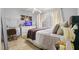 Cozy bedroom features a well-lit desk area, comfortable bed, and serene decor at 621 Bluebill Ln, Poinciana, FL 34759
