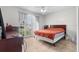 Bright bedroom featuring a large window, light colored walls and tile floors at 621 Bluebill Ln, Poinciana, FL 34759