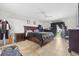 Spacious bedroom with a dark wood bed frame and ceiling fan at 621 Bluebill Ln, Poinciana, FL 34759